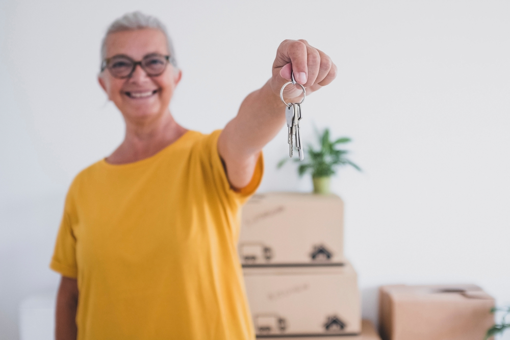 senior woman holding a set of keys