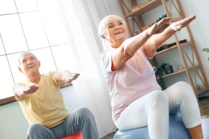 two seniors exercising on exercise balls