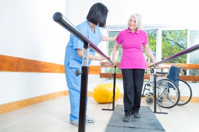 healthcare worker assisting a senior citizen with physical therapy