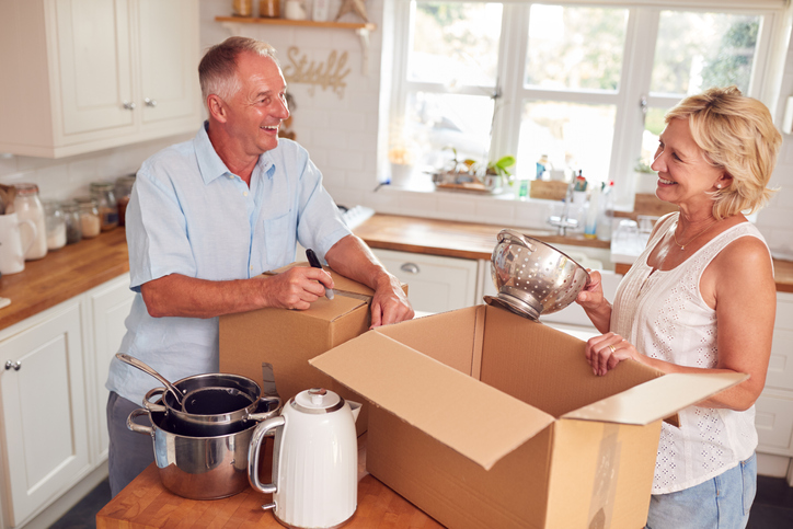 Two older adults unpacking after a move to a senior community